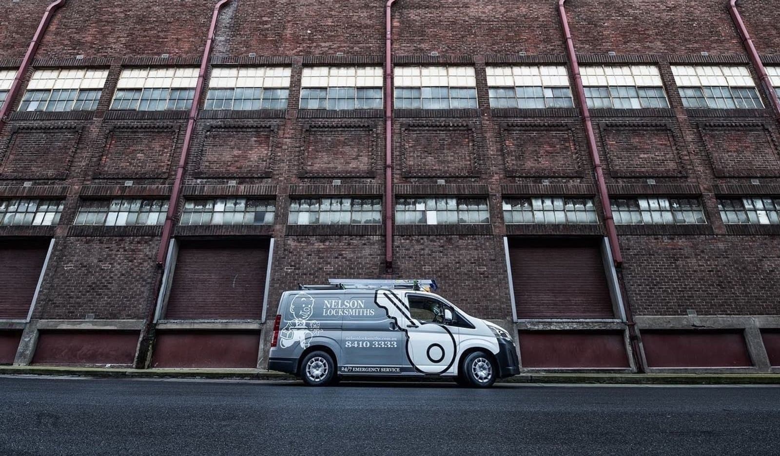 Nelson Locksmiths van outside a large brick warehouse