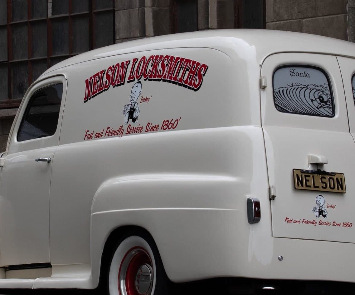 Signwriting on the Nelson panel van: the Nelson Locksmiths name, Lockey the running locksmith, and the old slogan “Fast and Friendly Service Since 1860”